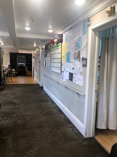 Hallway with multiple bulletin boards and decorations