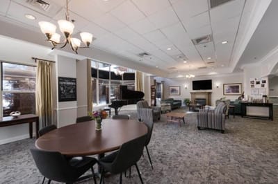 Bright common area with seating and piano