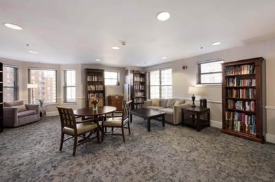 Bright common area with seating and bookshelves