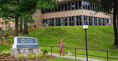 A resident walking a dog near the facility