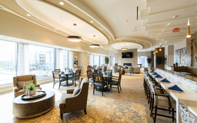Bright dining room with modern furnishings and large windows