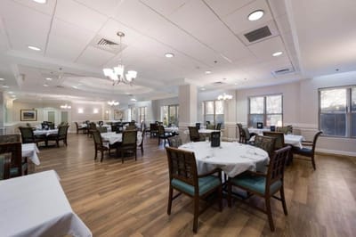 Dining room with tables and chairs set for a meal