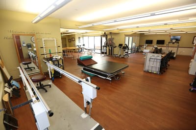A bright therapy room with fitness equipment