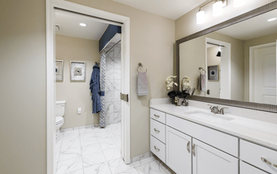 Bright, modern bathroom with marble tiles and vanity