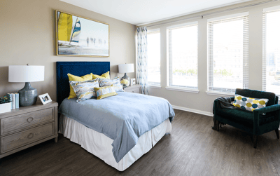 Bright and inviting resident room with a bed and windows