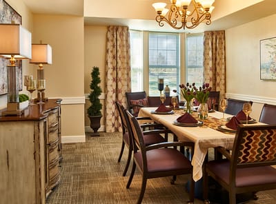 Elegant dining room setup with flowers and table settings