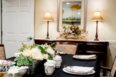 Table set with flowers and dining ware in a cozy dining room