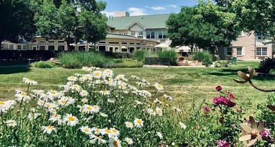 Exterior view of The Gardens at Columbine with flowers