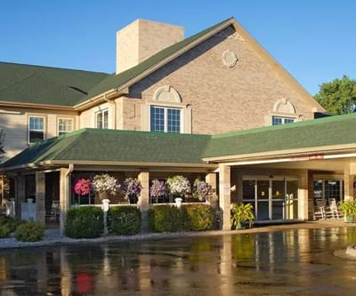 Exterior view of a senior living facility with gardens