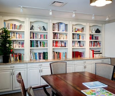 Cozy common area with bookshelves and dining table
