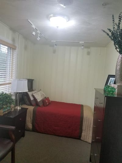 Private resident room with a bed and dresser