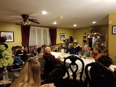 Residents and staff gathered in a common area for an event