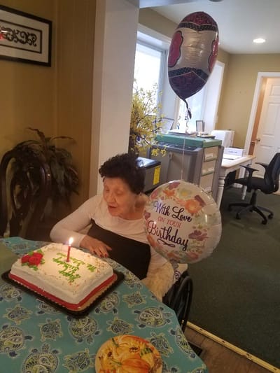 Resident celebrating a birthday with cake and decoration