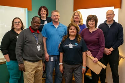 Staff members posing together in a facility common area