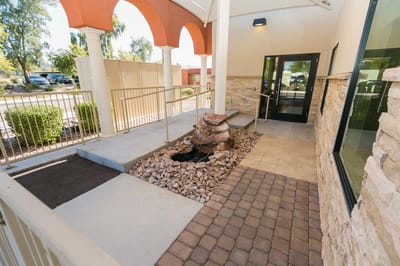 Entrance area with a rock feature and seating