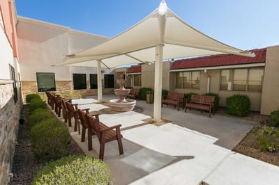 Shaded outdoor seating area with fountain