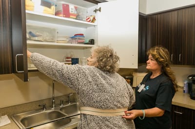 Staff assisting a resident in the kitchen