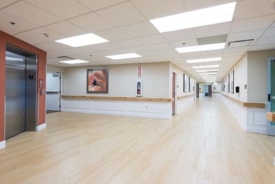 Wide view of a well-lit hallway in a facility