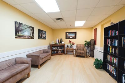 A cozy common area with bookshelves and seating
