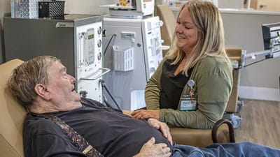 A caregiver interacting with a resident in a cozy setting