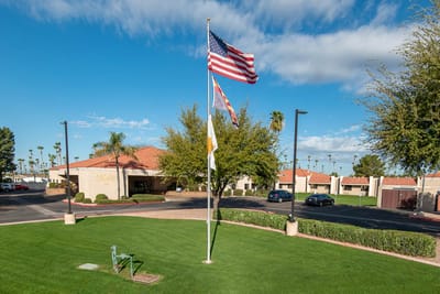 Exterior view of Mi Casa Nursing Center with flags