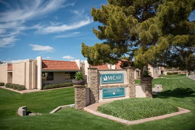 Facility exterior with logo and landscaping