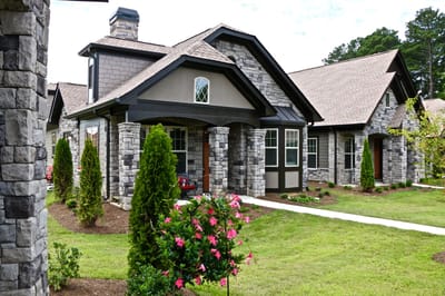 Exterior view of a senior living facility with landscaped gardens