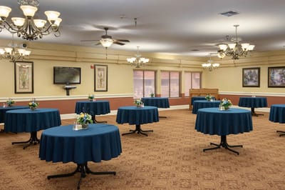 Interior view of a common area with tables and flowers