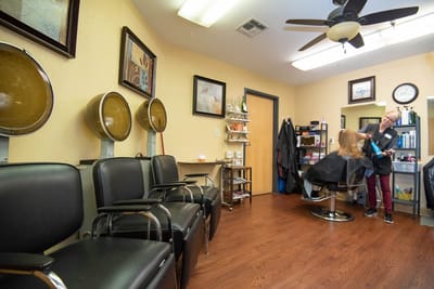 Residents receiving hair services in a salon area