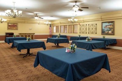 Interior view of a common area with tables and flowers