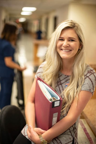 Staff member smiling in the facility lobby