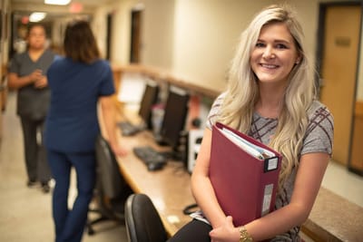 Staff member smiling in a common area
