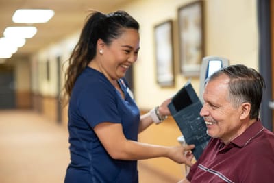 Staff assisting a resident in a hallway