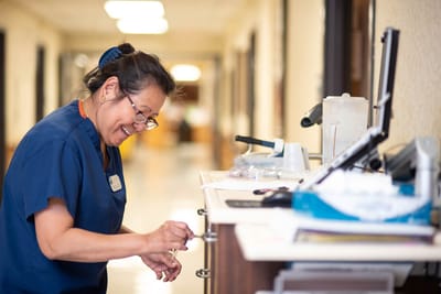 Staff member smiling while interacting with residents