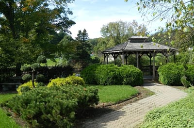 Serene garden area with a gazebo and well-manicured shrubs