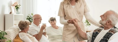 Staff interacting with seniors in a common area