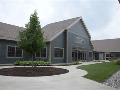 Exterior view of a senior living facility with green landscaping