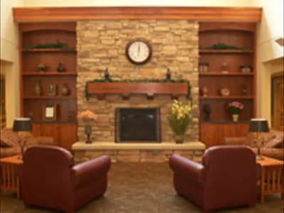 Cozy common area with plush seating and a stone fireplace