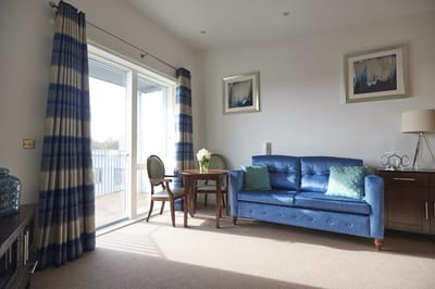 Bright and inviting common area with a blue sofa