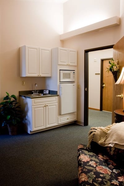 Interior view of a private resident room with kitchenette
