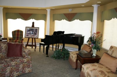 A cozy common area in the facility with a piano