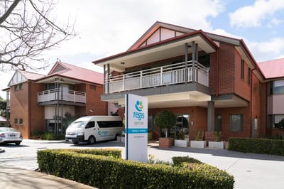 Exterior view of Regis Shenley Manor facility with van