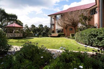 Garden area with a gazebo and seating near the building