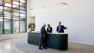 Reception area with staff assisting a resident