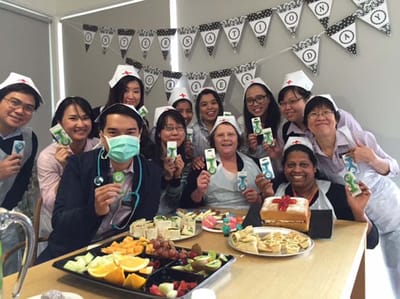 Staff and residents celebrating with food in a common area