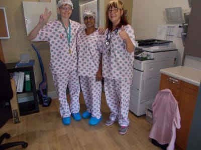 Staff members in scrubs posing for a photo
