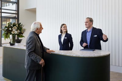 Staff assisting a resident at the reception