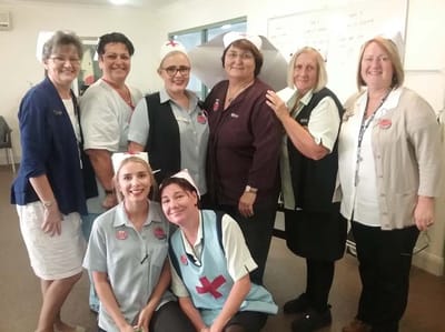 Staff members posing together in a common area