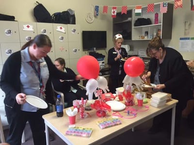 Staff preparing for a celebration in an activity room