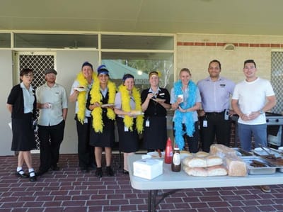 Staff members celebrating outdoors with food and drinks